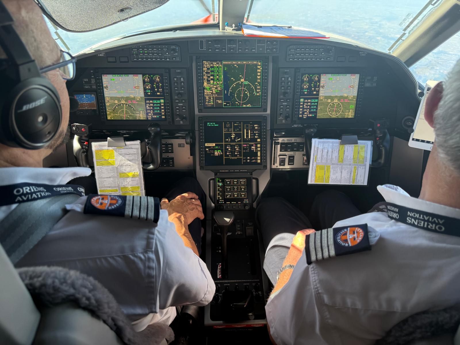 Air ambulance cockpit showing flight instruments and medical crew on a repatriation flight from Pakistan