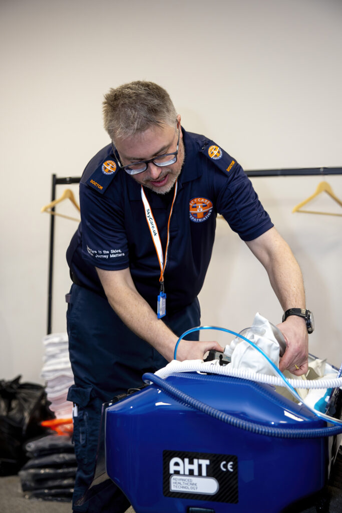 Neonatal air ambulance team preparing newborn incubator for flight