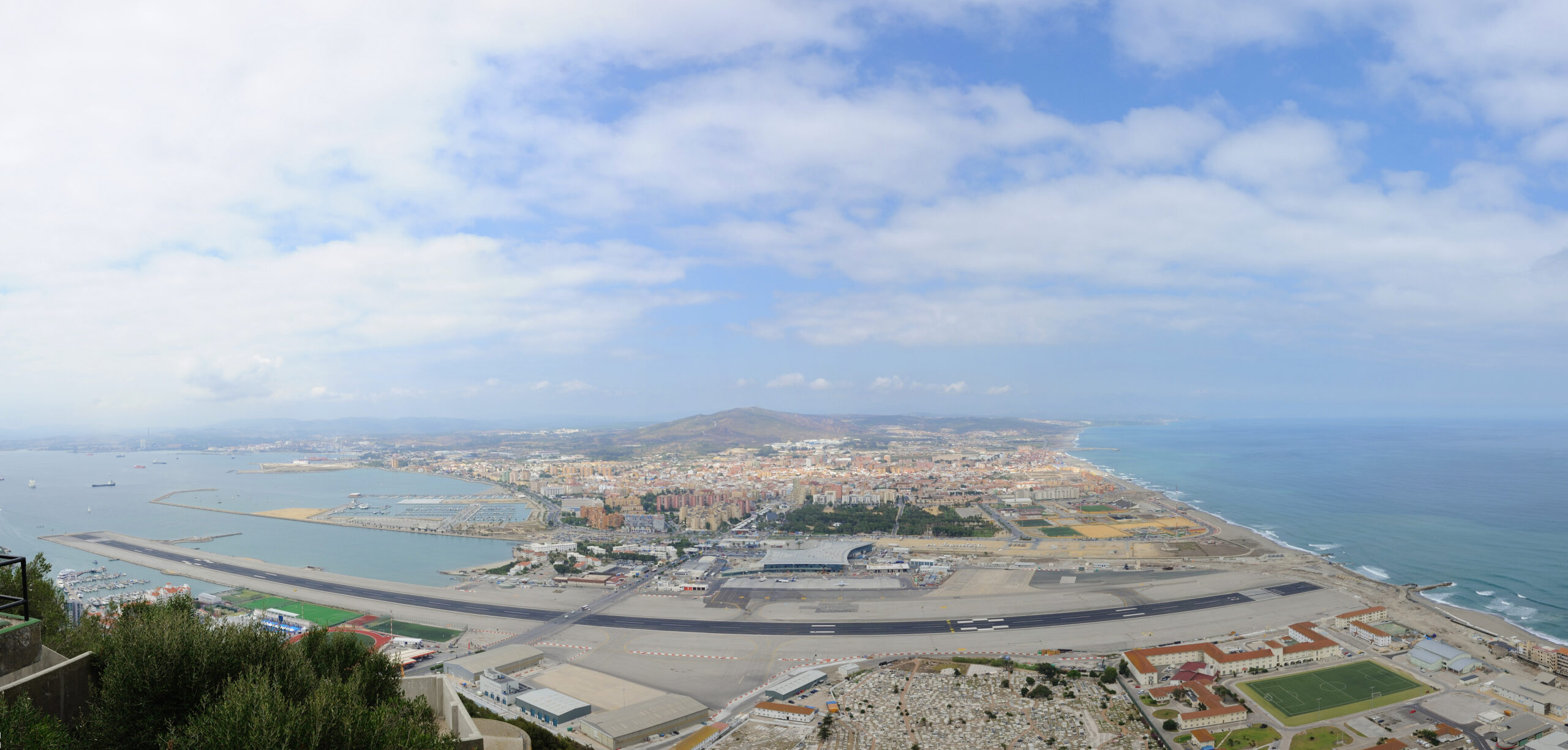 Aerial view of Gibraltar International Airport, showcasing the runway and surrounding areas, relevant to air ambulance services.