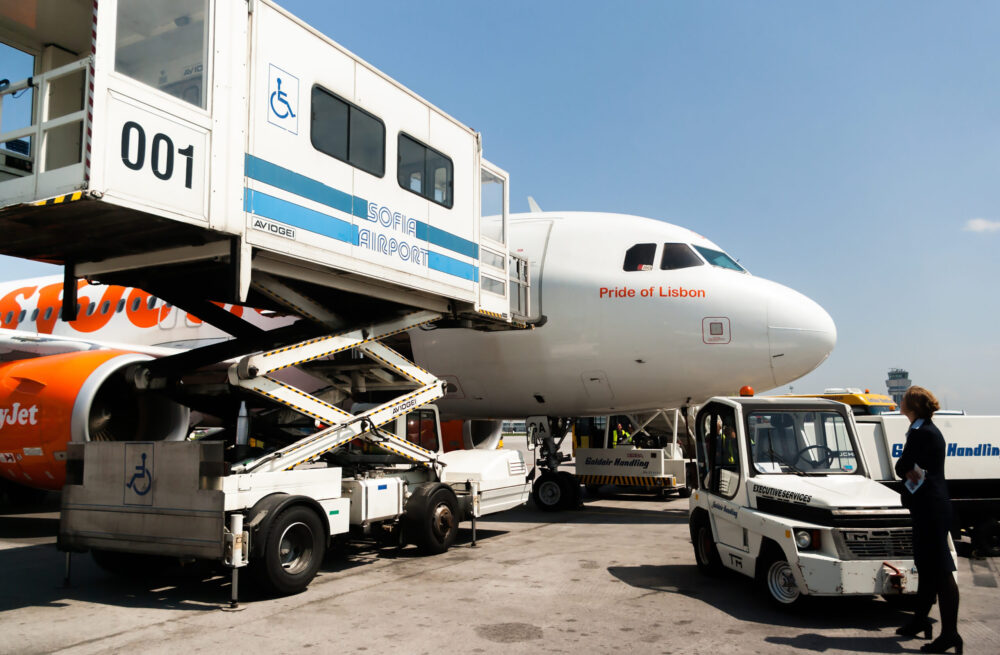 Passenger boarding a commercial aircraft via lift for a medically assisted flight with SkyCare 