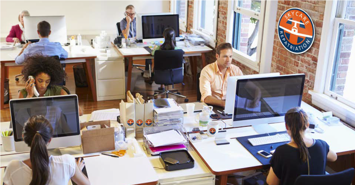 SkyCare coordinator taking a booking for a commercial medical escort service in the company office 