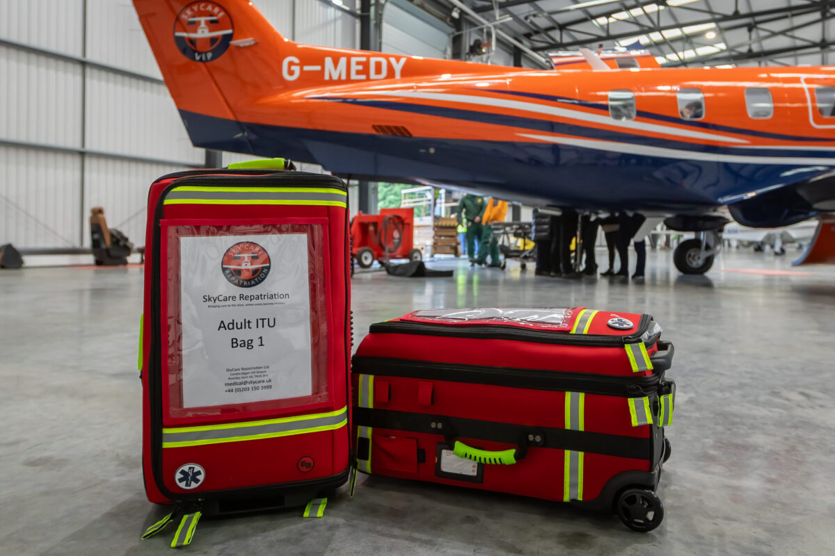 Intensive care air ambulance aircraft with medical crew preparing for patient transfer