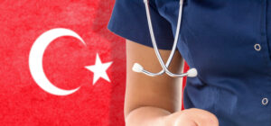 Doctor in medical uniform standing in front of Turkish flag, representing healthcare in Turkey