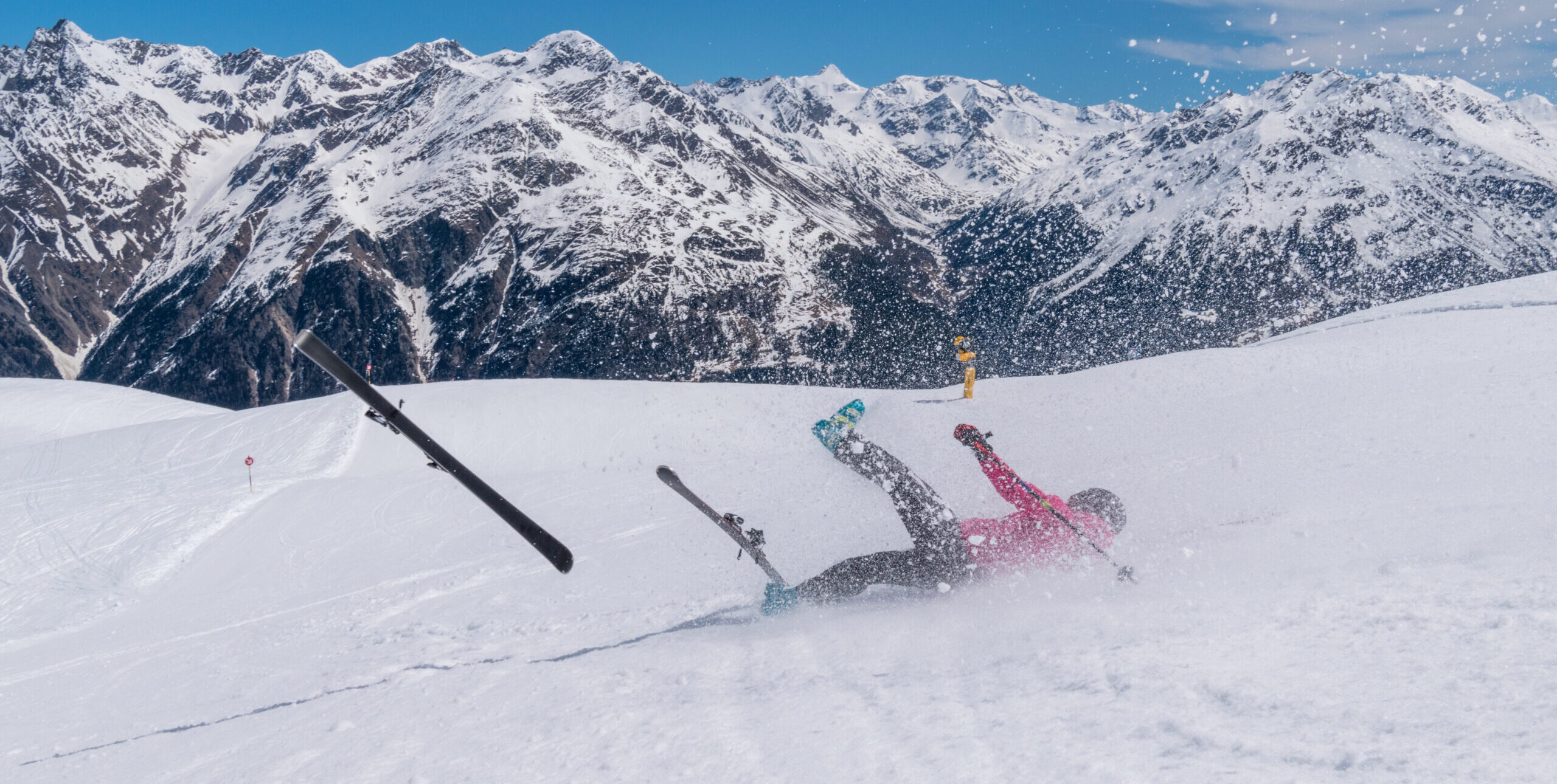 Skier crashing on a snowy slope