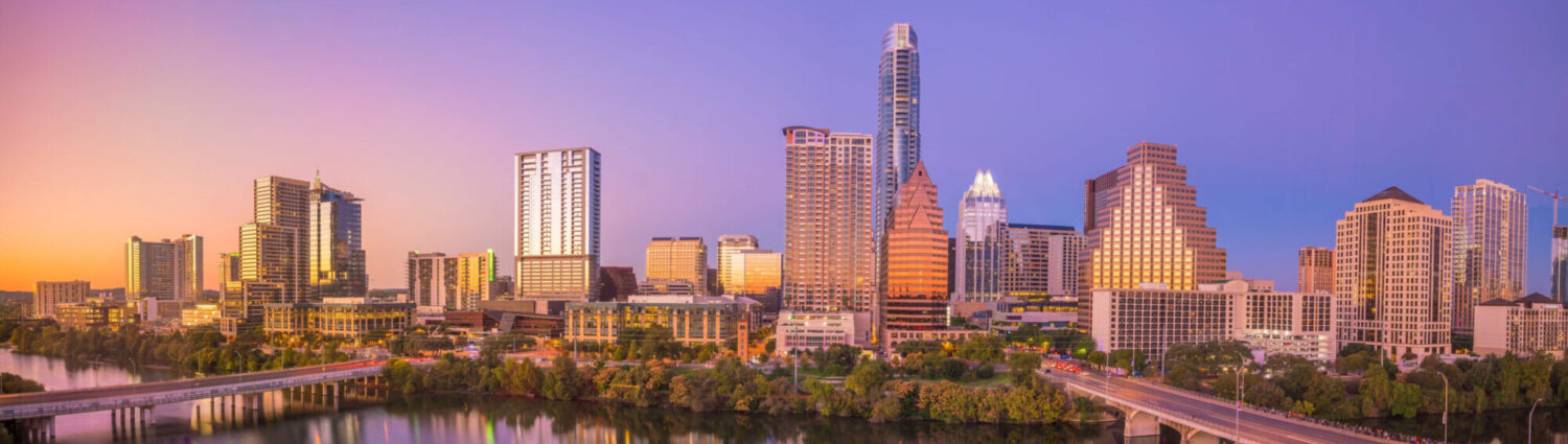 Air ambulance aircraft preparing for medical repatriation in Texas with a sunset skyline in the background