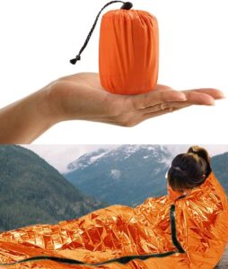 Survival blanket keeping an injured skier warm after an accident abroad Emergency medical help while skiing – survival blanket used after ski injury abroad