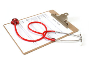 Stethoscope resting on a hospital medical report used for medical transport decisions