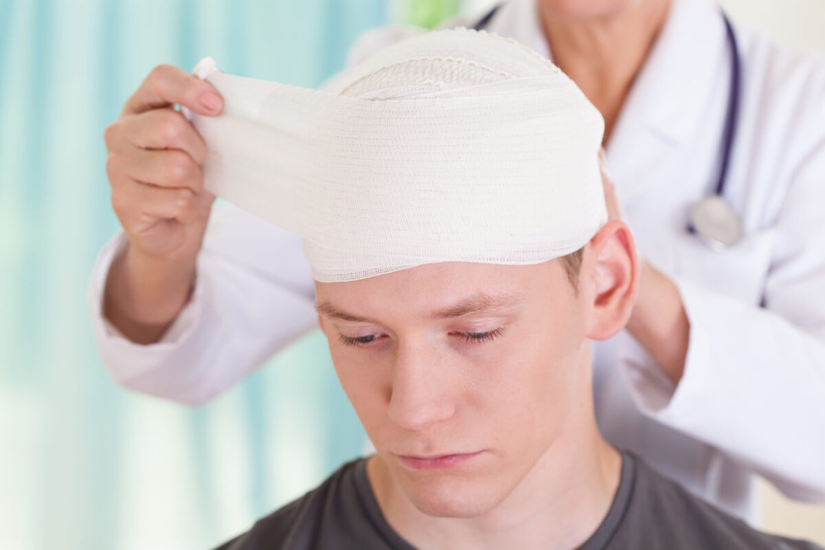 Head injury during ski holiday being assessed by mountain medic 