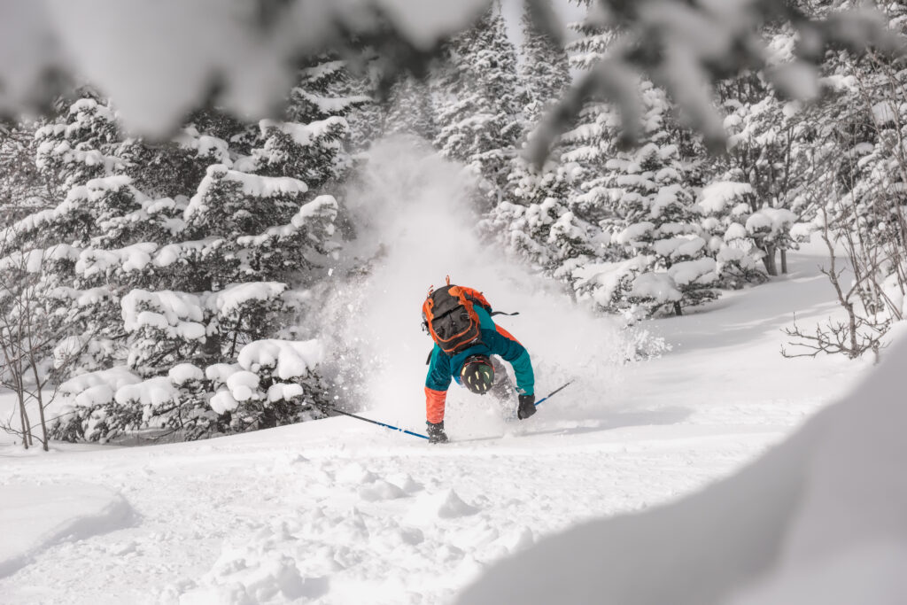 Ski injuries abroad – injured skier receiving help on the slopes after a fall