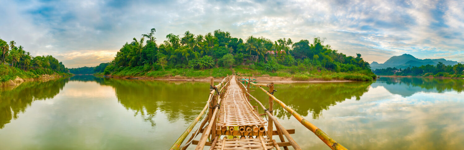 Bamboo bridge in Luang Prabang symbolising remote access and air ambulance needs in Laos