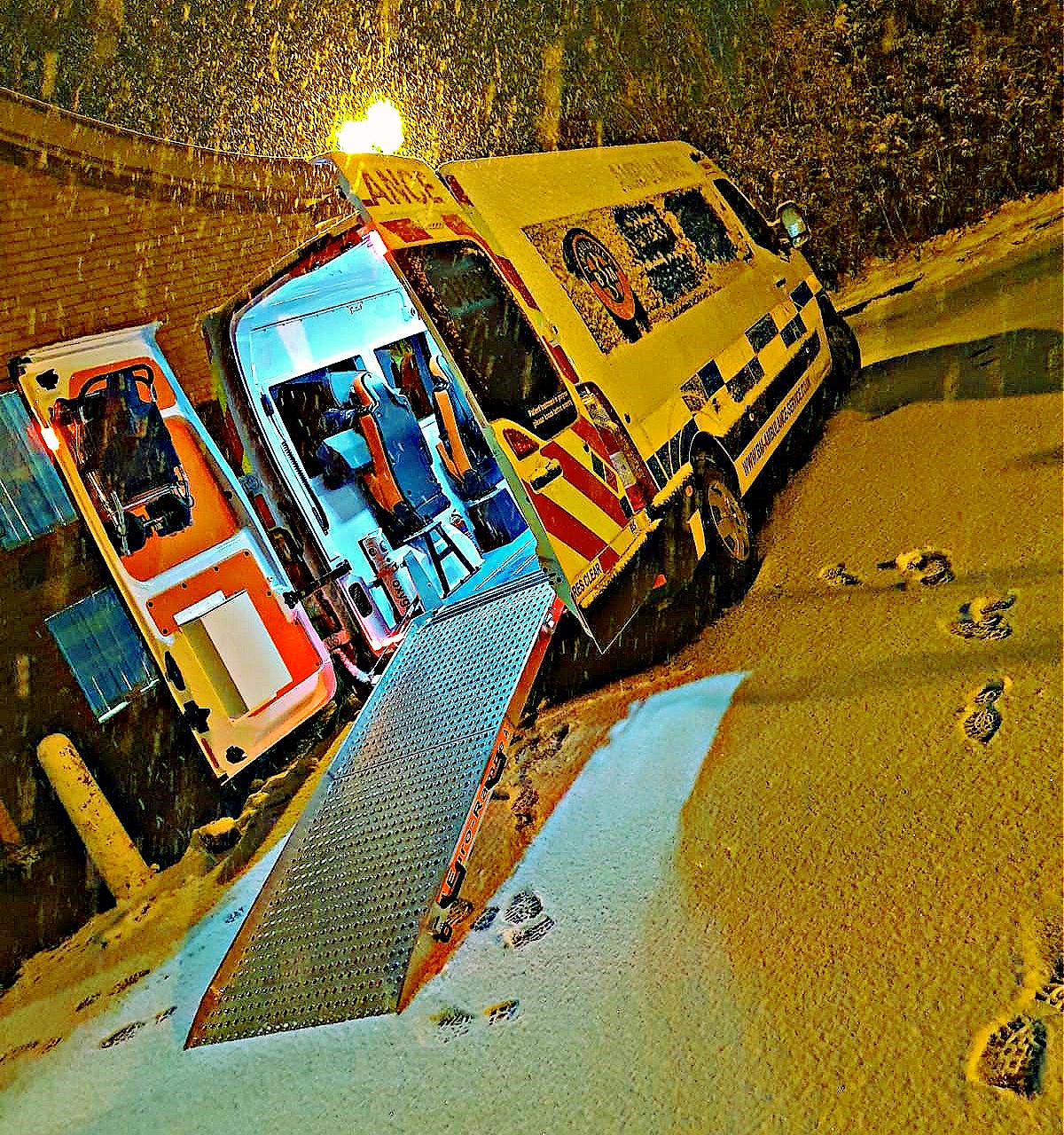 SkyCare ground ambulance preparing to repatriate a ski injury patient from the Italian Alps to the UK by road 