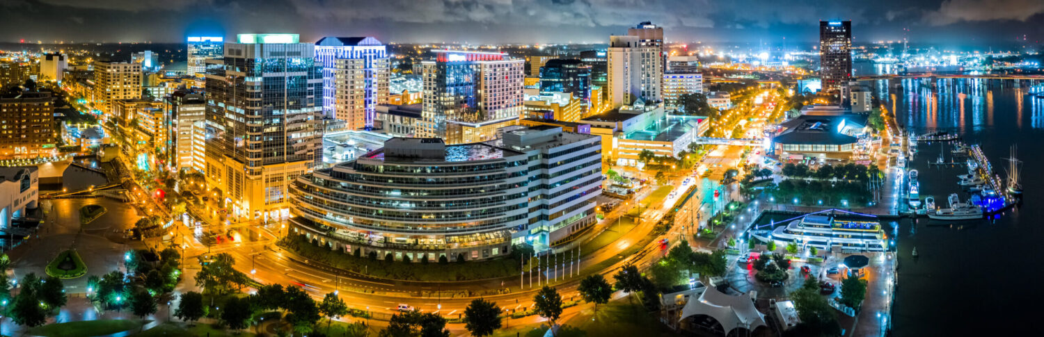 Air ambulance services in Norfolk, Virginia at night with city skyline in view.
