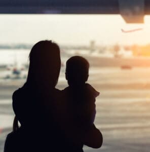 Child traveller at an airport supported by a professional SkyCare child flight escort
