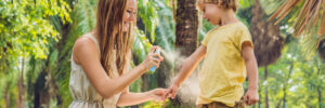 Mosquito biting skin showing malaria abroad risk for travellers in tropical regions