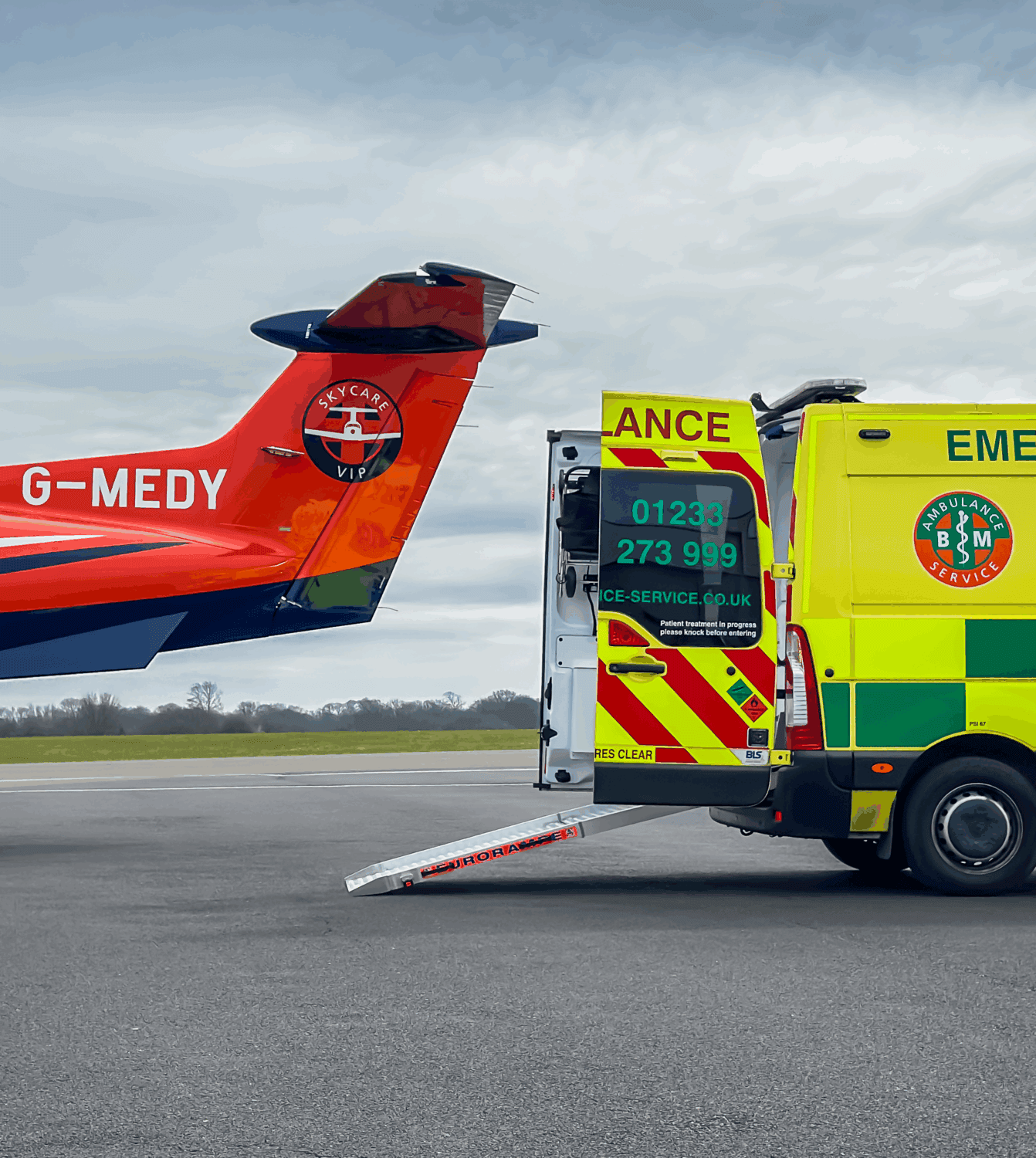 Air ambulance and ground ambulance positioned for an aircraft-to-ambulance patient transfer