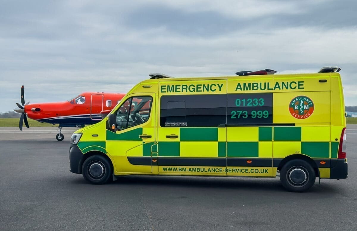 Ground ambulance meeting an aircraft airside for a patient transfer at a London airport